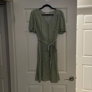 Light green dress with tie around waist and buttons down the front.